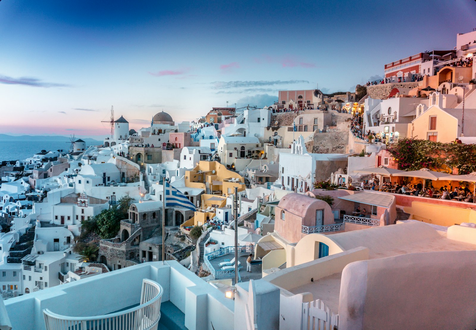 White-washed buildings and blue domes of Santorini at sunset